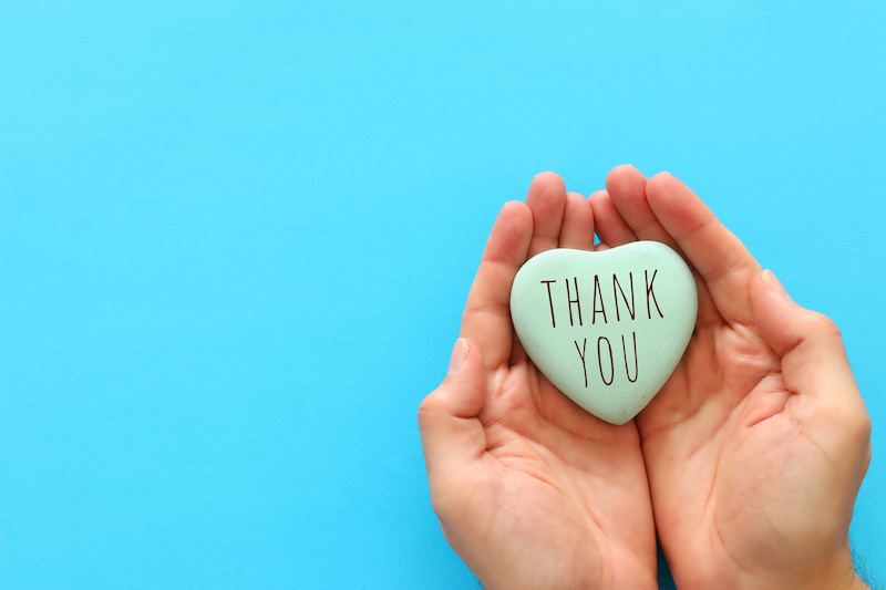 top view image holding heart with the text thank you