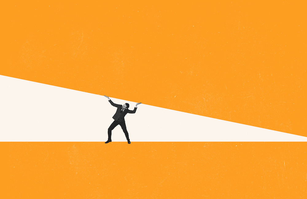 Man under pressure holding up a large block