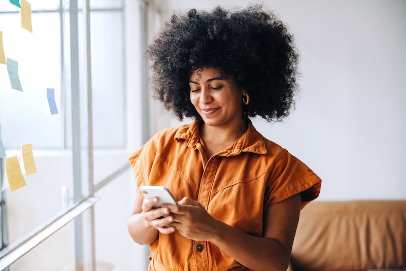 businesswoman using a smartphone in a creative office