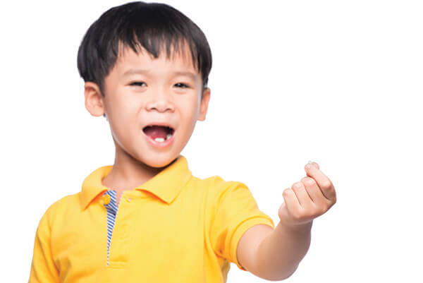 Little boy showing his lost tooth for the tooth fairy