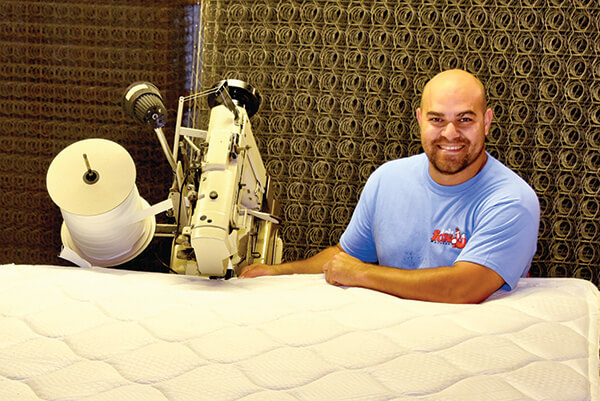 Joe Carter is among five full-time factory employees working in the company’s production facility. Fox Mattress specializes in two-sided mattresses.