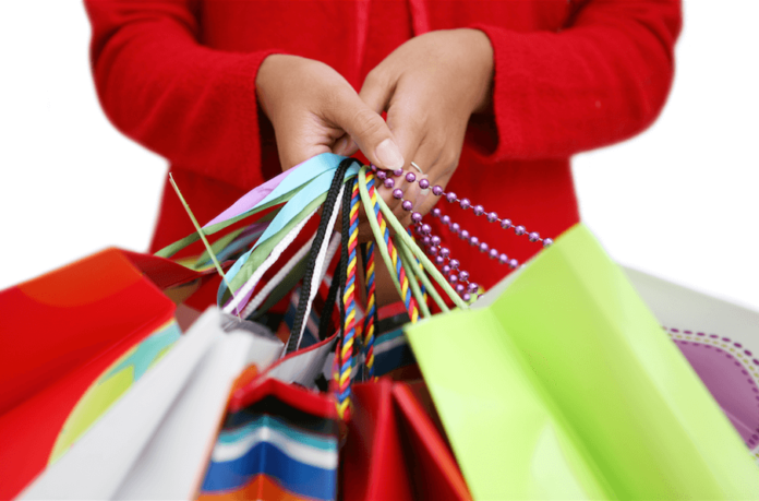 Woman’s hands holding colorful shopping bags