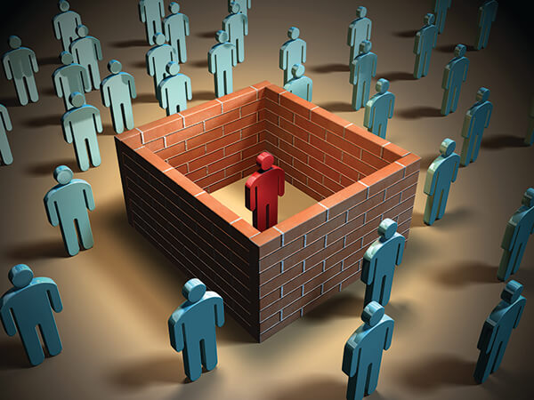 A brick wall isolates an individual from other people. Digital illustration.