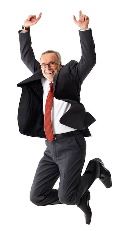 man in suit jumping for joy
