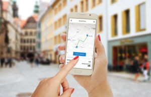 Find drive smartphone app in woman hand. City map, trail, driver