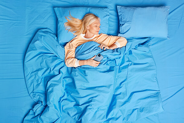 woman-asleep-on-blue-sheets