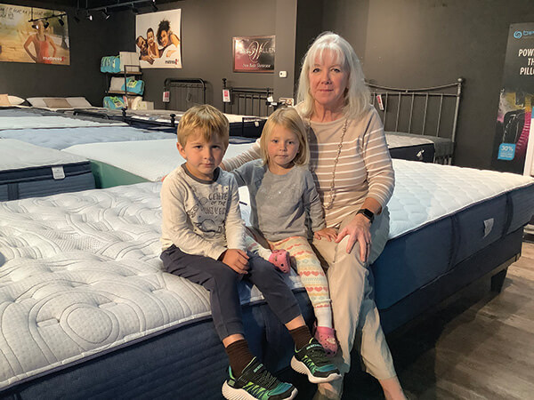 FAMILY CONNECTIONS Keenehan sits on a mattress with two of her grandchildren, Ryan Duke, 4, and Reilly Bauswell, 2.