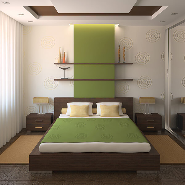 Platform bed with green coverlet.