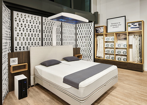 MULTISENSORY SELLING Interactive bed experiences provide “wow” moments in the new Sleep Number store design. The digital screen above this smartbed in the Edina, Minnesota, store helps shoppers see, hear and feel how the company’s beds respond to them and their sleep needs.