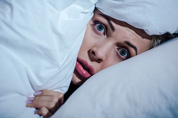 Woman-hiding-under-covers
