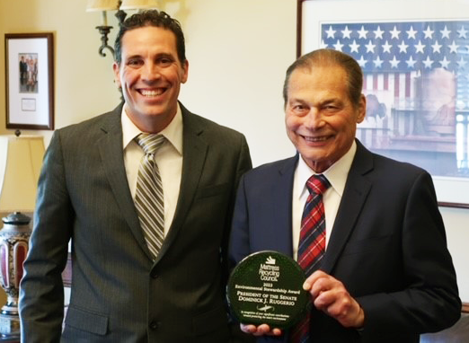 Dan McGowan, left, Northeast senior coordinator for the Mattress Recycling Council, presents the 2023 MRC Environmental Stewardship Award to Sen. Dominick J. Ruggerio (D-North Providence), president of the Rhode Island Senate.