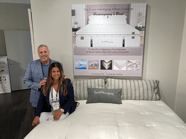 Bedding Industries of America CEO Stuart Carlitz and his wife and executive assistant, Elis Carlitz, pose by an Ernest Hemingway mattress.