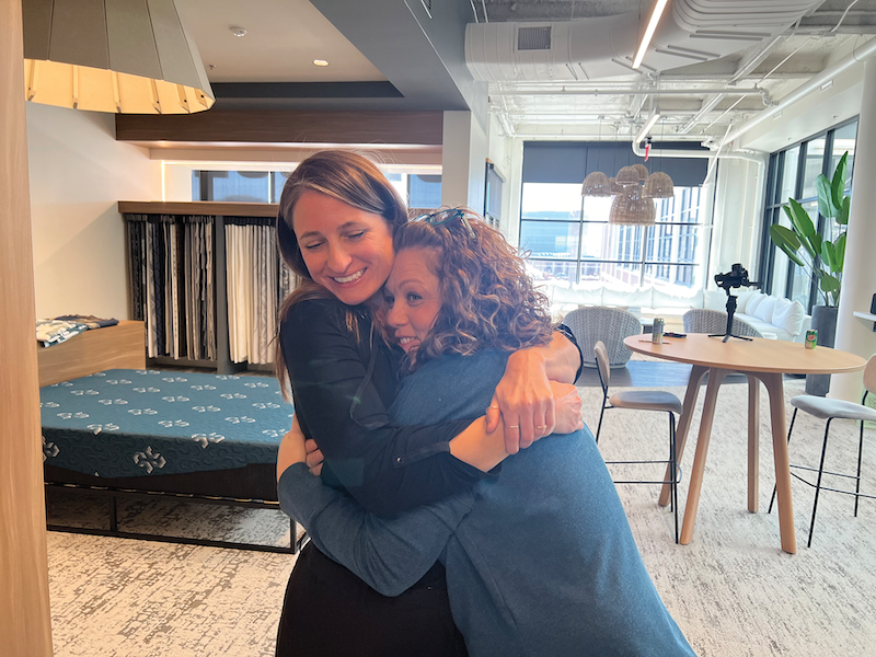 Mattress fabric design. TIGHT KNIT Tara Bulla, right, a Culp designer of 25 years, hugs fellow designer Tanja Tusa. Bulla says the company is so close that it’s like family.