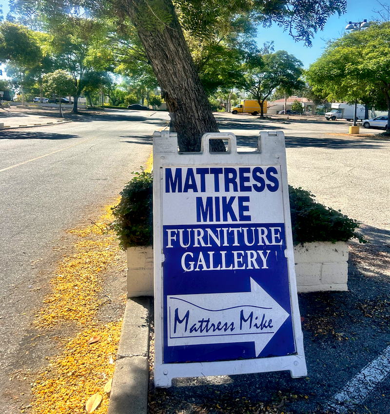 LOOK HERE A sandwich board in the parking lot directs shoppers to the store. 