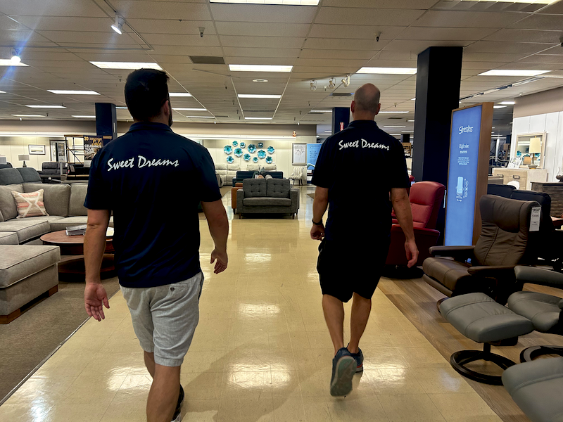 SWEET DREAMS Garret Gustason (left) and Michael Gustason give Sleep Savvy a tour of the expansive store which offers seating, bedding, massage chairs and more.