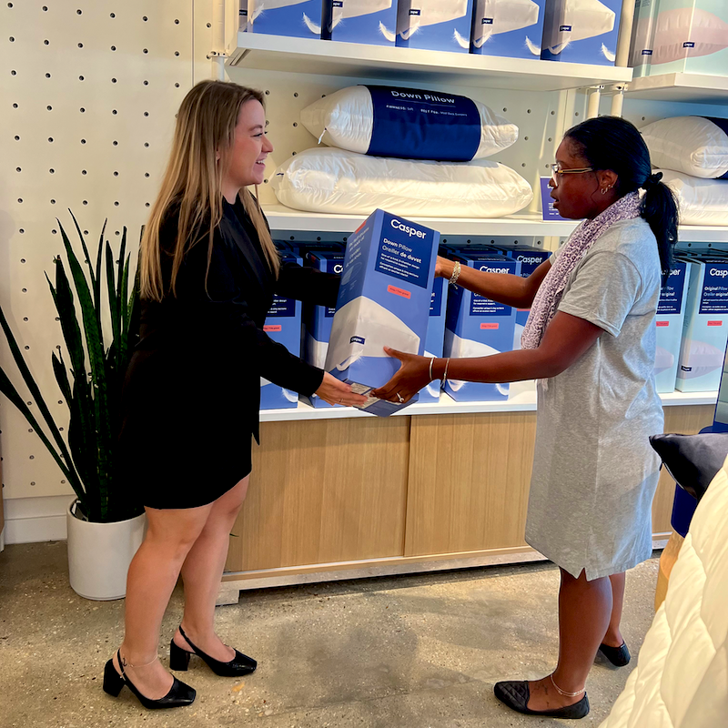 Casper retail innovation. Laura Nash shows Kathryn Greene a down pillow, one of the company’s many accessory offerings.