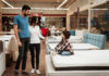 Parents mattress shopping with a child